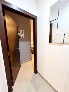 a hallway with a door and a mirror at Samborondón Luxury Room by Adriana in SamborondÃ³n +5 photos