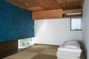 a room with a couch and a blue wall at hanare in Tokyo