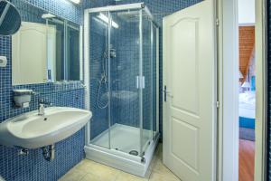 a bathroom with a glass shower and a sink at Balatonfői Yacht Club in Balatonkenese