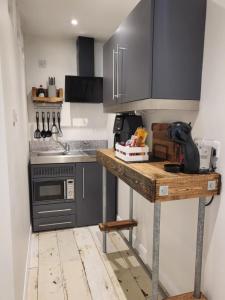 a kitchen with a wooden table in a room at Rūm by the beach in Camber +18 photos
