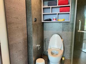 a small bathroom with a toilet in a stall at Room in Kamala at Citygate Condo in Kamala Beach +6 photos