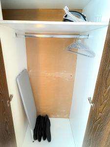 an open door of a closet with a towel at Destiny Hotel - 1601 in Manila
