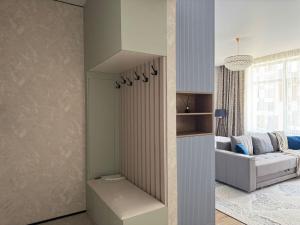 a living room with a couch and a table at Astana Design Nest in Taldykolʼ