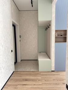 an empty room with a door and a hallway at Astana Design Nest in Taldykolʼ +4 photos