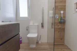 a bathroom with a toilet and a glass shower at Apartamento Rincón de la calma in Alcudia +11 photos