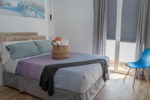 a bedroom with a bed with a basket on it at Apartamento Rincón de la calma in Alcudia
