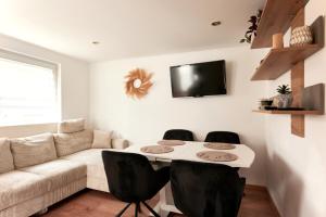 a living room with a couch and a table and chairs at Elegant 3BD Holiday Home in Prime Location of Vienna in Vienna