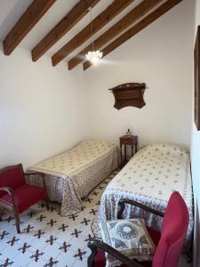 a room with two beds and a chair at La Torre Blai in Jijona +14 photos