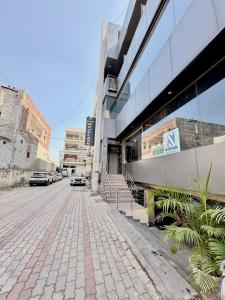 a street with cars parked in front of a building at Hotel JB Grand Residency Zirakpur Chandigarh # lift #Balcony Rooms # Banquet Hall # Family Rooms in Chandīgarh