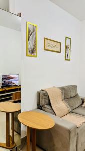 a living room with a couch and two tables at 1403 Apto 2 Qtos Cabedelo João Pessoa in Ilha da Restinga +55 photos