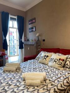 a bedroom with a large bed with pillows on it at La Ramblé in Turin