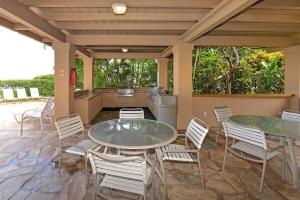 カハナにあるPaki Maui 207 · PM 207 BeachFront 1BD w Ocean Viewのパティオ(テーブル2台、椅子付)、キッチンが備わります。