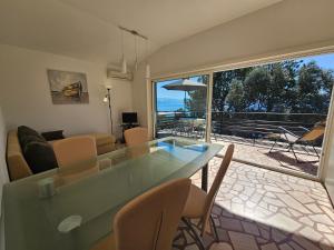 a living room with a table and a large window at VILLA MEDITERANEA direct at the sea in Novi Vinodolski