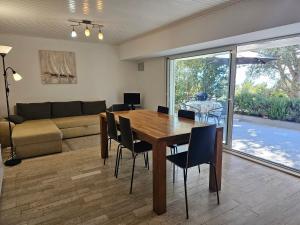 a living room with a wooden table and chairs at VILLA MEDITERANEA direct at the sea in Novi Vinodolski +47 photos
