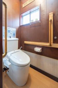 a bathroom with a white toilet and a window at 甲府木ノ間Kofu Konoma in Kofu +14 photos