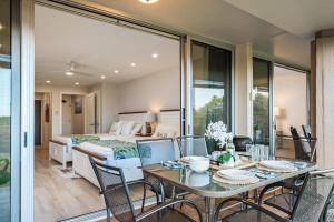 a bedroom with a bed and a table and chairs at Eldorado K104 · EL K104 Spacious 1BD w Near Beach in Kahana