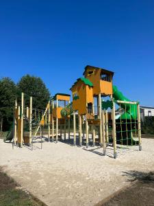 un parque infantil con un tobogán en la arena en Mobile home Camping Siblu Les Charmettes 4, en Les Mathes 26 fotos más