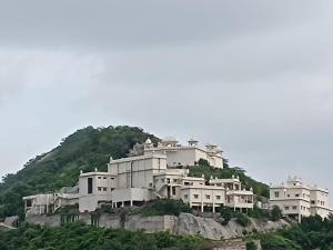 a group of white houses on a hill at daulatvilass by Grandview mansionhotel in Udaipur