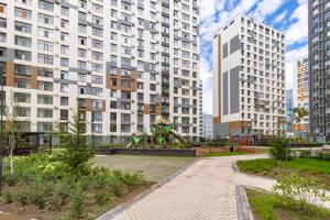 a park in a city with tall buildings at Astana Design Nest in Taldykolʼ