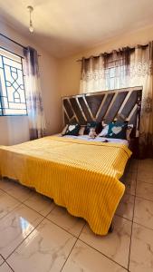 Postel nebo postele na pokoji v ubytování Nyota House