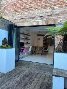 ein offenes Wohnzimmer und ein Esszimmer mit Glasschiebetüren in der Unterkunft Life's A Beach - cosy, luxury cottage in Ashley Cross, Poole in Parkstone