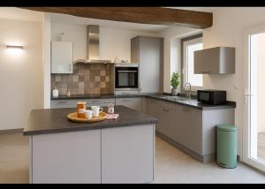a kitchen with a table with a plate of food on it at Maison de village chaleureuse avec terrasse 3 étoiles in Serrières-en-Chautagne