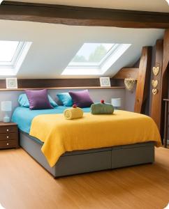 a bedroom with a large bed with a yellow blanket at Maison de village chaleureuse avec terrasse 3 étoiles in Serrières-en-Chautagne +25 photos