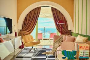 a living room with a couch and a chair at Dooga Ins-Retro Pastelland Seaview Bathtub by Doogahome Homestay in Johor Bahru
