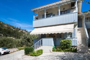 a house on the hill with a car parked outside at Pansion Margarita in Agios Nikitas