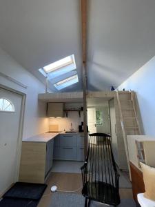 a kitchen with a loft conversion with a skylight at Guesthouse at Roland's in Uppsala +4 photos
