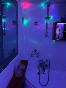 a bathroom with a tub and a shower with lights at Różany Ogród in Rymanów-Zdrój +42 photos