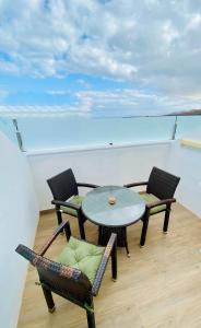 a balcony with a table and chairs on a yacht at Paisaje Lunar in Tinajo