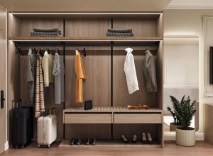 a walk in closet with shoes and clothes at Hotel By Holiday in Rinas