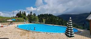a swimming pool in the middle of a mountain at Pyrenees family T3 in Aulus-les-Bains