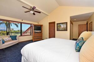 a bedroom with a white bed and a ceiling fan at Kaanapali Royal D302 · KRL D302 Updated Kaanapali 2BD on Golf Co in Lahaina +57 photos