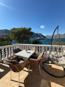 a patio with a table and chairs on a balcony at Apartment LANA on the seashore in Kamenarovići