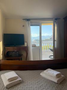 a bedroom with a bed and a window with a view at Apartment LANA on the seashore in Kamenarovići