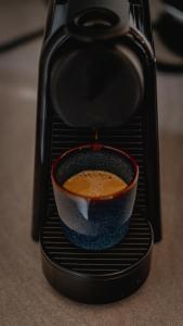 a cup of coffee in a espresso machine at Stone Suite Zakopane in Zakopane +33 photos