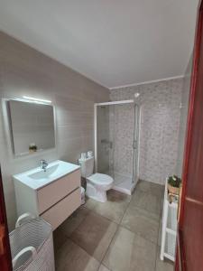 a bathroom with a toilet and a sink and a shower at Barloveto 3 apartament in Playa Honda +6 photos