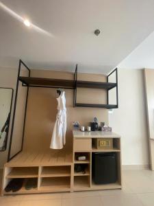 a room with a dress hanging on a wall at The Light Arena Ocean Tower in Cam Ranh International Airport
