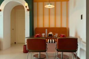 a dining room with a table and two chairs at Dooga Ins-Retro Opera Deco Seaview Bathtub by Doogahome Homestay in Johor Bahru