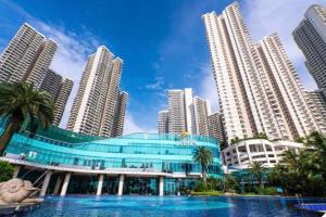 a building in front of a city with tall buildings at Dooga Ins-Retro Opera Deco Seaview Bathtub by Doogahome Homestay in Johor Bahru