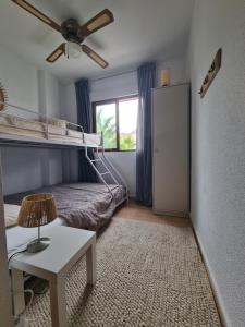 a bedroom with a bunk bed and a ceiling fan at Casa La Paz Bolnuevo in Bolnuevo +31 photos