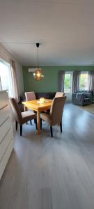 a dining room with a wooden table and chairs at Arctic Cabin - Mellomgaard on southern Kvaløya #sauna & bbq hut on site! in Tromsø