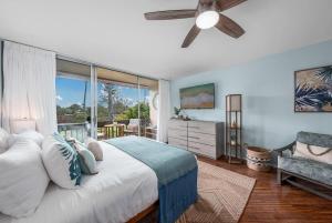 a bedroom with a large bed and a ceiling fan at Napili Ridge G16 · NR G16 Updated Napili Condo Walk to Napili Ba in Kahana +41 photos