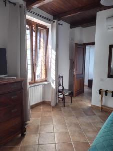 a living room with a chair and a window at Villa Marini in Trevignano Romano +23 photos
