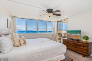 a bedroom with a white bed and a large window at Royal Kahana 909 · RK 909 OceanFront Condo w Beautiful Ocean Vie in Kahana +67 photos