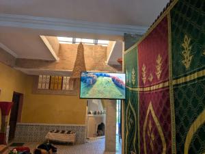 a living room with a painting on the wall at Dar saafia in Marrakech