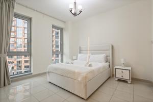 Una cama o camas en una habitación de Stylish 1BR in Downtown - 5 Min to Burj & Mall 14 fotos más
