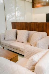 a living room with a couch and two couches at Sundowners in Chilaw